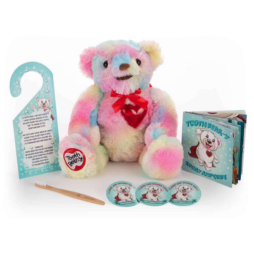 Tooth Bear-y Kit in Rainbow. Includes a bamboo toothbrush, caring and sharing stickers, a door hanger, story book and the rainbow Tooth Bear-y