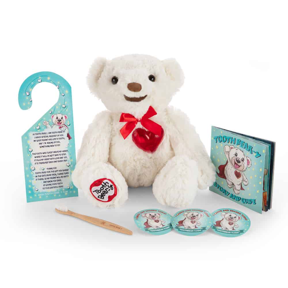 Tooth Bear-y Kit in White. Includes a bamboo toothbrush, a storybook, caring and sharing stickers, door hanger and the white Tooth Bear-y stuffed animal
